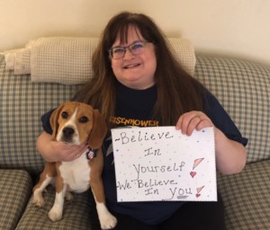 School nurse with sign that reads, "Believe in yourself. We believe in you!"
